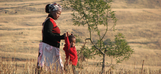 lady and child walking in the veld