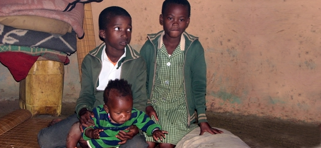 poor children sitting in their kraal