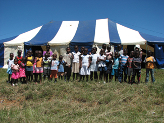 Children outside the play centre tent
